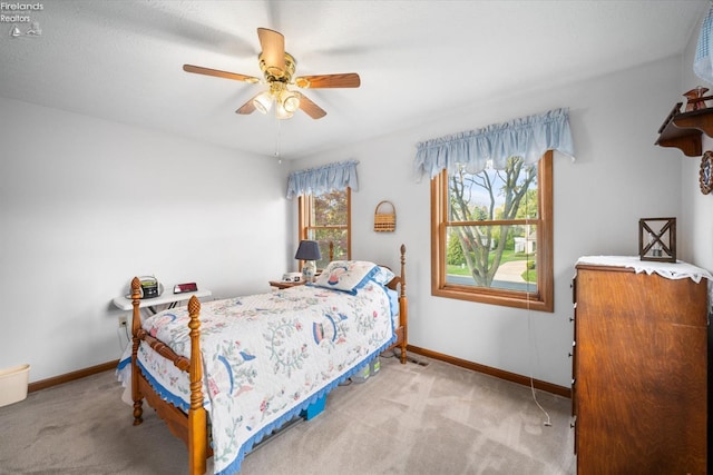 bedroom with light colored carpet and ceiling fan