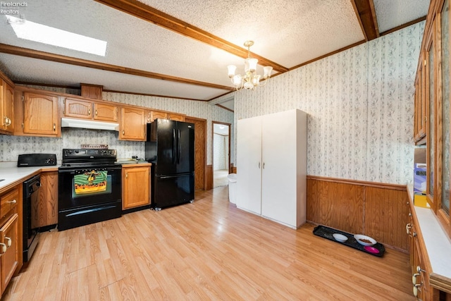 kitchen featuring black appliances, a textured ceiling, hanging light fixtures, light hardwood / wood-style flooring, and lofted ceiling with beams