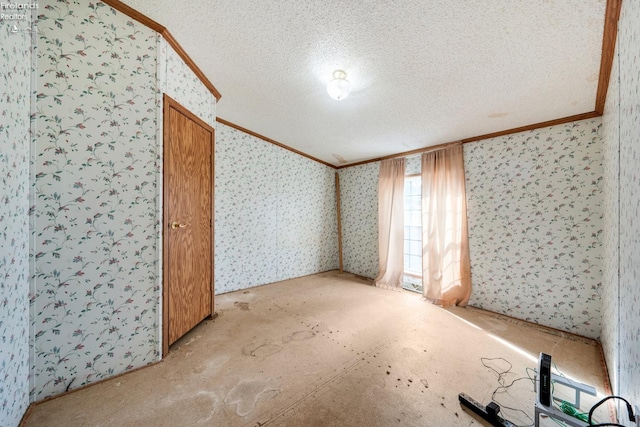 unfurnished room with a textured ceiling and ornamental molding