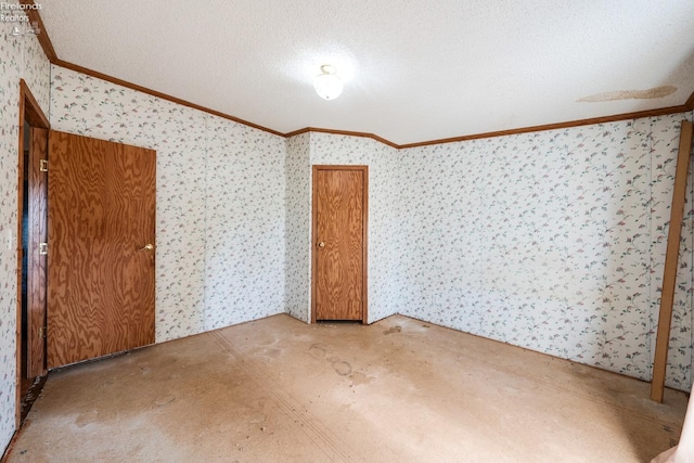 empty room with a textured ceiling and crown molding