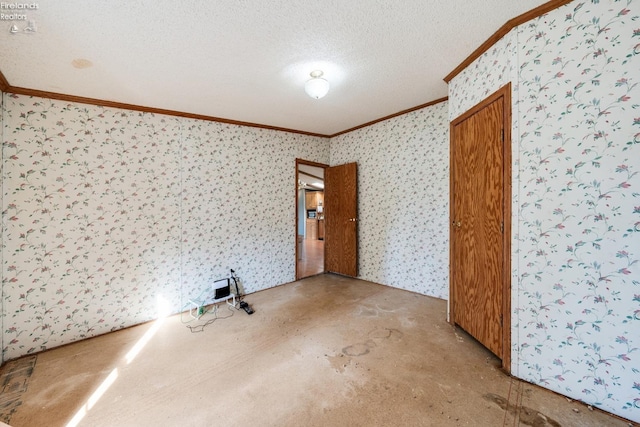 empty room with a textured ceiling and ornamental molding