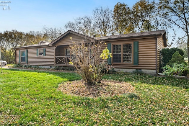 cabin with a front yard