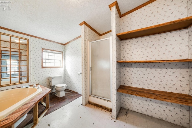 bathroom featuring a textured ceiling, toilet, plus walk in shower, and crown molding