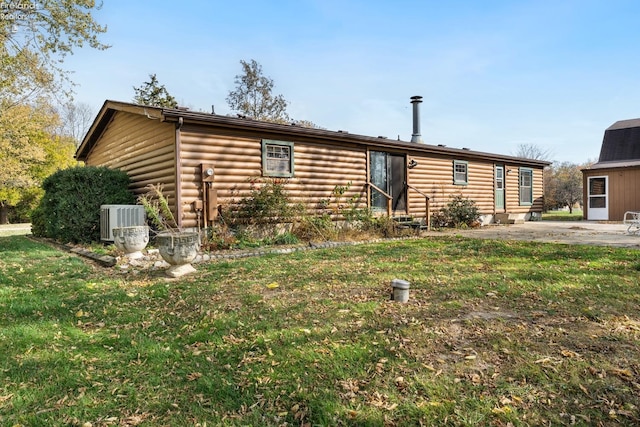 cabin with central air condition unit and a front yard