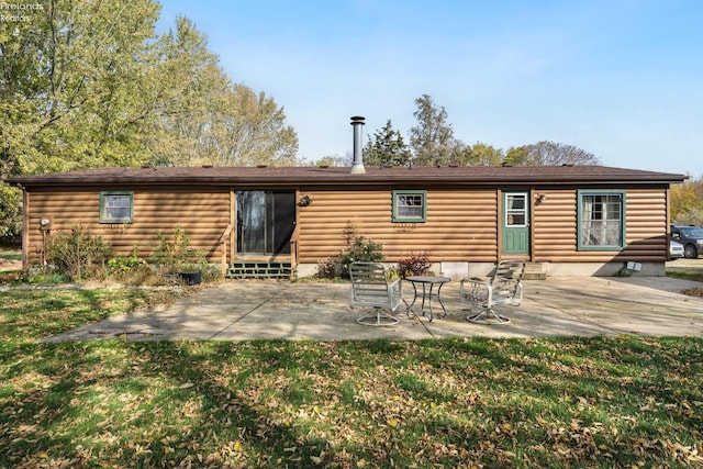 rear view of property featuring a yard and a patio