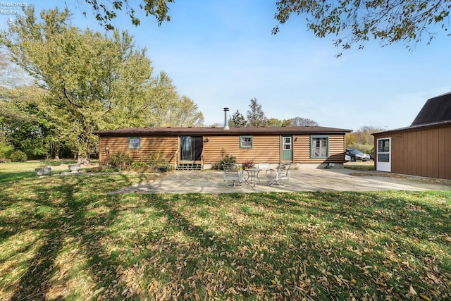 back of house with a yard and a patio area