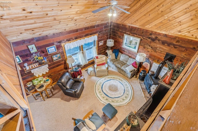 living room with wood ceiling, lofted ceiling, wooden walls, and ceiling fan