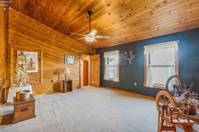 interior space featuring wood walls, carpet, wooden ceiling, and ceiling fan