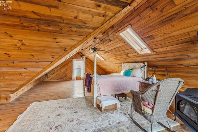 unfurnished bedroom with wood ceiling, vaulted ceiling with skylight, light hardwood / wood-style flooring, and wooden walls