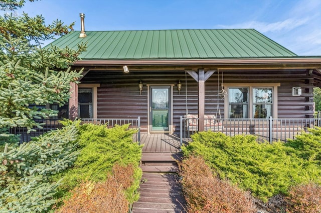 14136 Township Rd Unit 108, Findlay, OH 45840 - log home with a standing seam roof, log siding, a porch, and metal roof