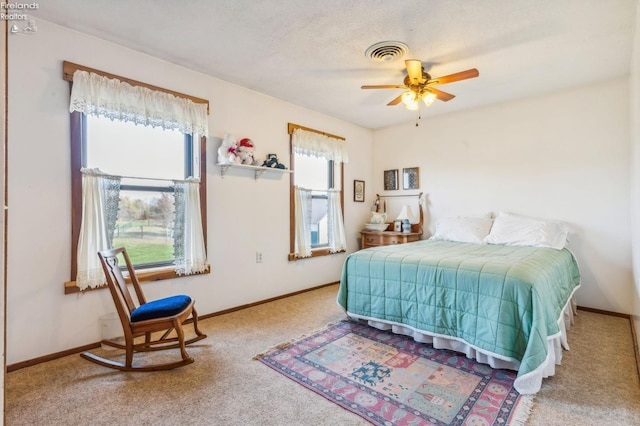 carpeted bedroom with a textured ceiling and ceiling fan