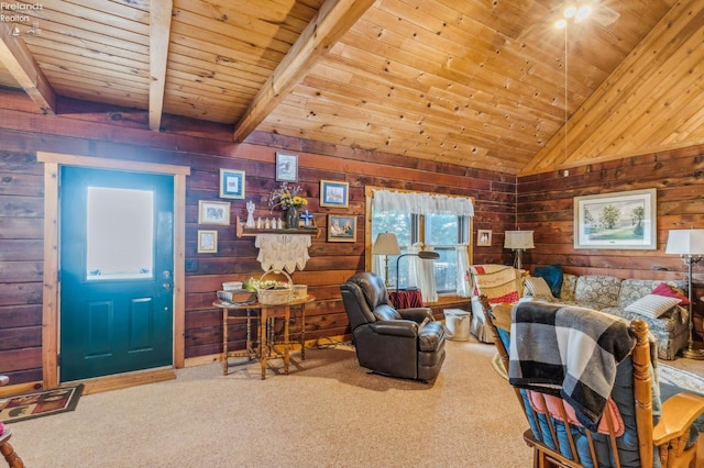 carpeted living room with wood walls, lofted ceiling with beams, and wooden ceiling