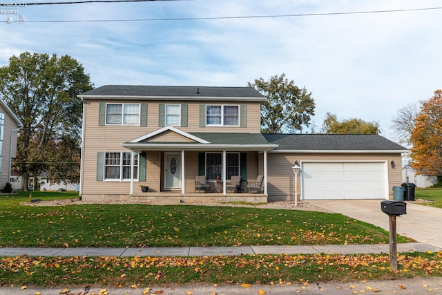 view of front facade featuring a front yard, a porch, and a garage