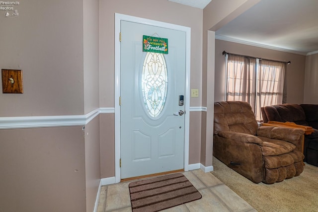 entrance foyer featuring light carpet and crown molding