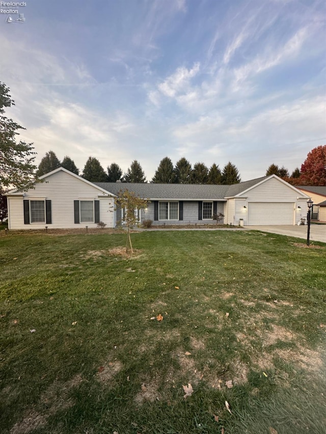 single story home with a garage and a front yard