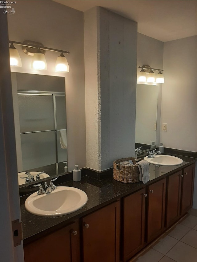 bathroom featuring vanity, tile patterned floors, and a shower with shower door