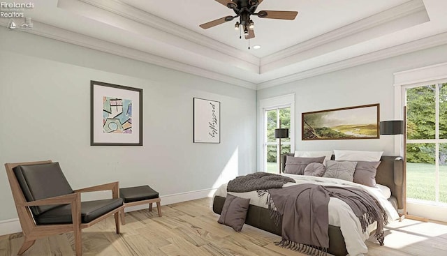 bedroom featuring a raised ceiling, multiple windows, and ceiling fan