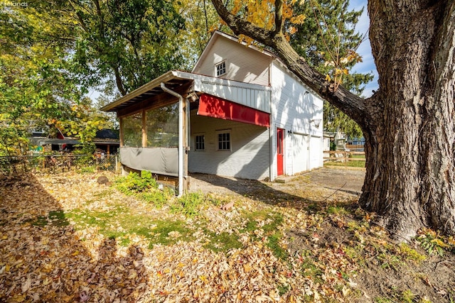 view of home's exterior with a sunroom