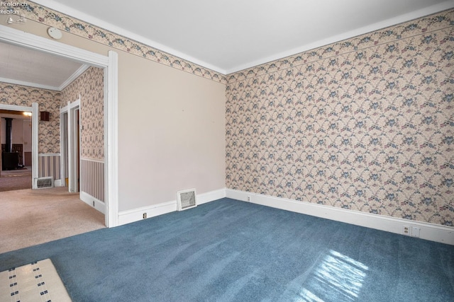 carpeted empty room with crown molding