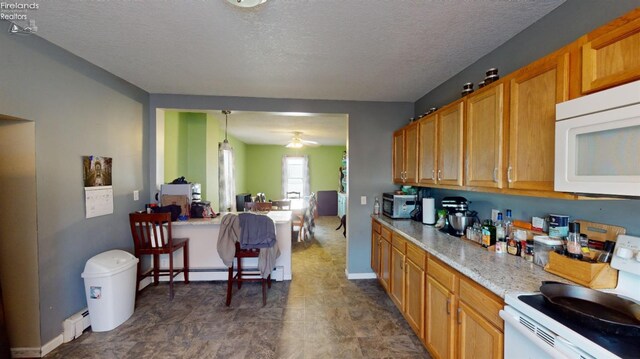 kitchen featuring decorative light fixtures, a textured ceiling, a baseboard heating unit, white appliances, and ceiling fan