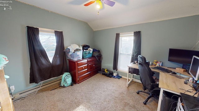 home office with a wealth of natural light, ceiling fan, vaulted ceiling, and light colored carpet