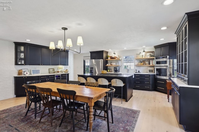 25 Edison, Milan, OH 44846 - dining room featuring light wood-style flooring, a chandelier, and recessed lighting