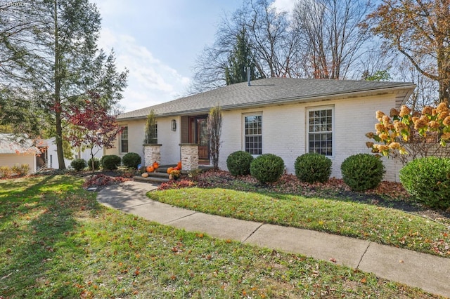 single story home with a front lawn