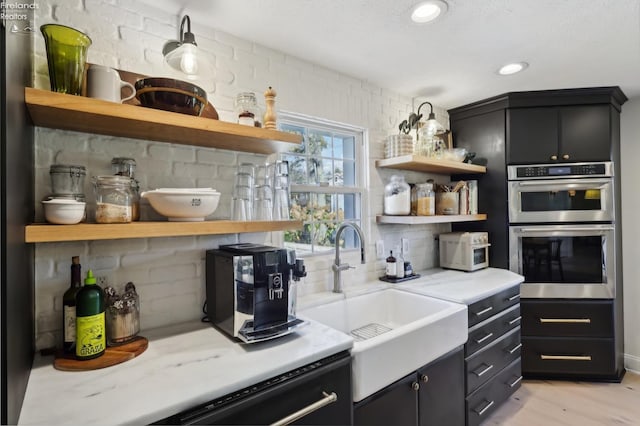 25 Edison, Milan, OH 44846 - kitchen featuring open shelves, a sink, double oven, light countertops, and recessed lighting