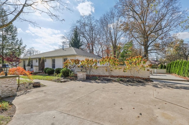 25 Edison, Milan, OH 44846 - view of home's exterior with stucco siding and concrete driveway