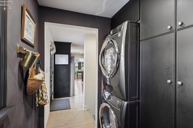 25 Edison, Milan, OH 44846 - laundry room featuring stacked washer / drying machine, light wood-style floors, cabinet space, and baseboards