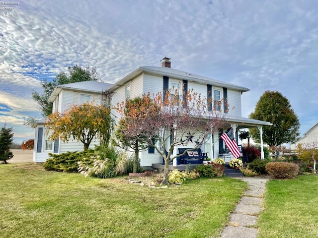 view of front of house with a porch and a front lawn