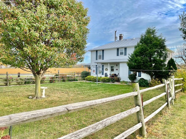 view of front of house featuring a rural view and a front yard