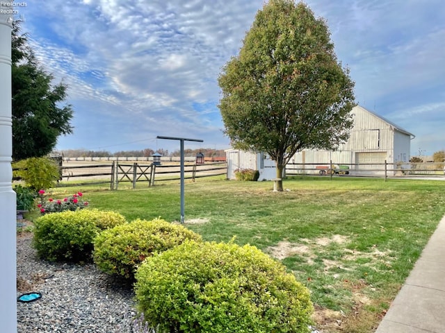 view of yard featuring an outdoor structure and a rural view