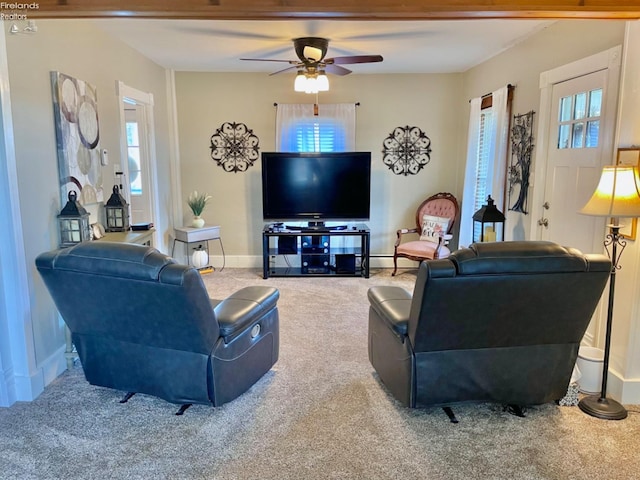 living room featuring ceiling fan, carpet, and a wealth of natural light