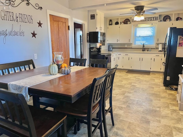 dining space with sink and ceiling fan