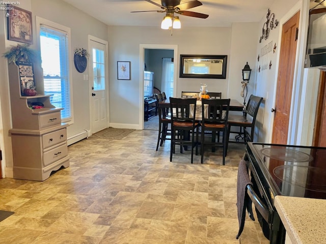 dining area with a baseboard radiator and ceiling fan