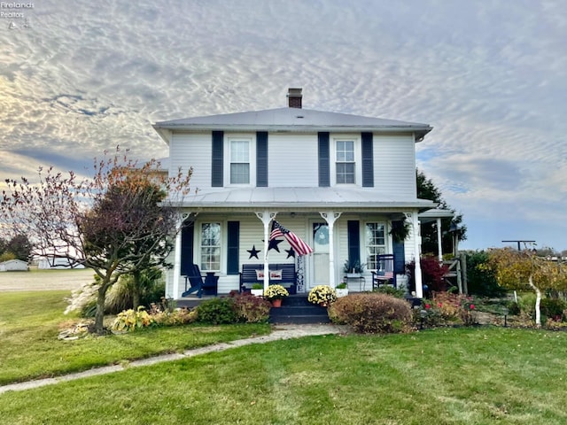 view of front of house featuring a front yard and a porch