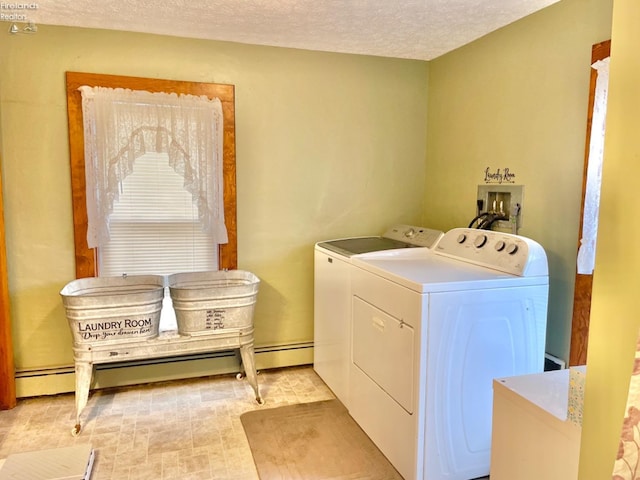 laundry area featuring washer and dryer, a textured ceiling, and a baseboard radiator