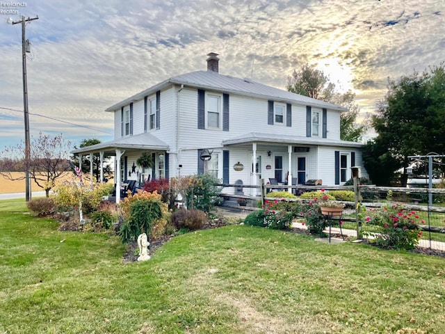 view of front of home featuring a lawn and a porch