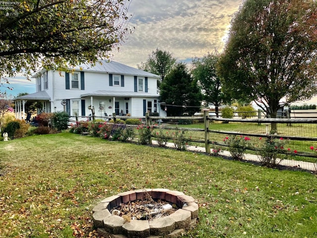 yard at dusk featuring an outdoor fire pit