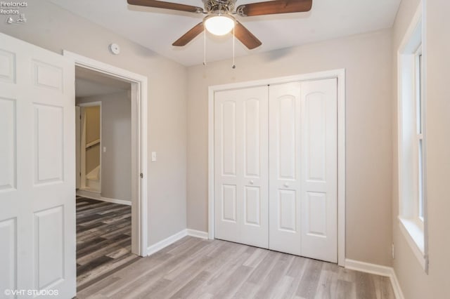 unfurnished bedroom featuring light hardwood / wood-style flooring, a closet, and ceiling fan