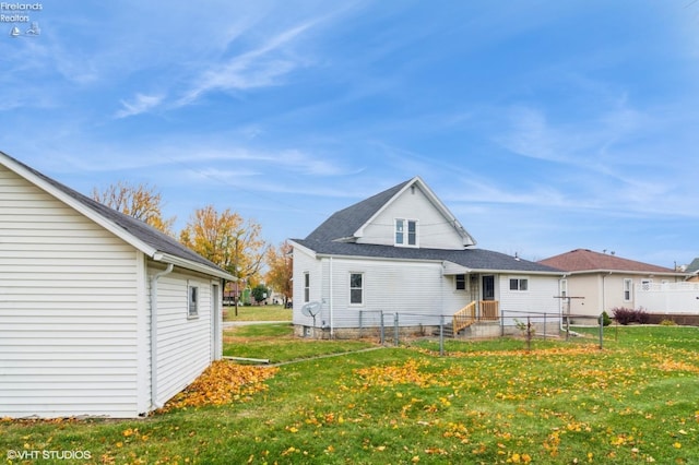 rear view of house with a yard