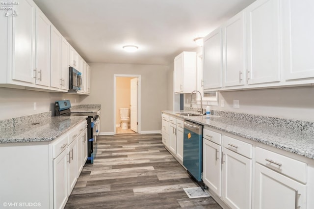 kitchen featuring wood-type flooring, sink, black range with electric stovetop, stainless steel dishwasher, and white cabinets