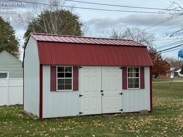 view of outbuilding featuring a yard