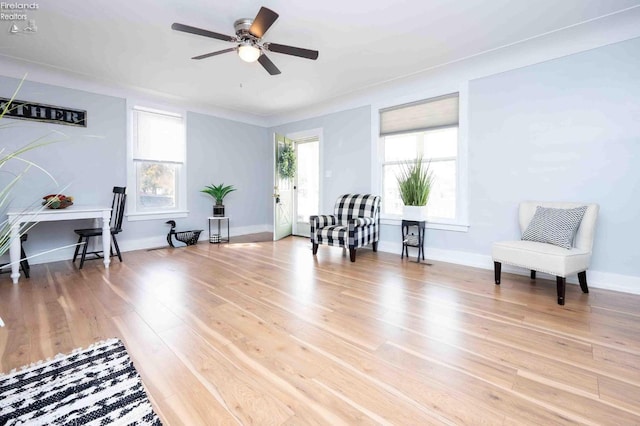 sitting room featuring wood-type flooring and ceiling fan