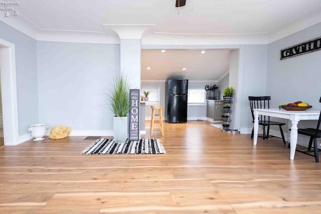 interior space featuring light wood-type flooring and crown molding