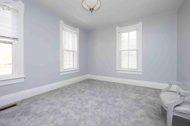 sitting room with plenty of natural light and carpet flooring