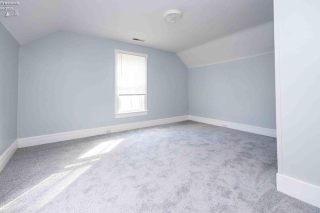 bonus room featuring carpet and lofted ceiling