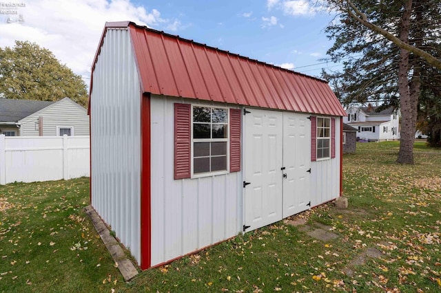 view of outbuilding with a lawn