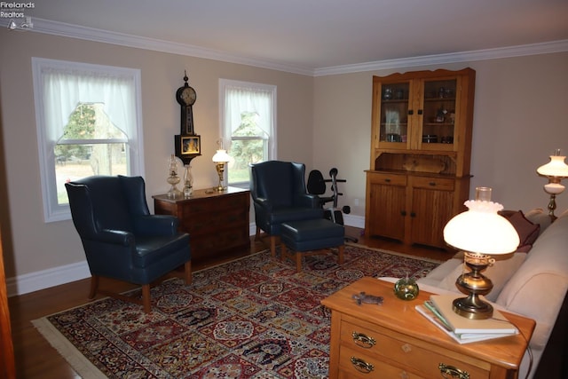 living area featuring plenty of natural light, hardwood / wood-style flooring, and crown molding